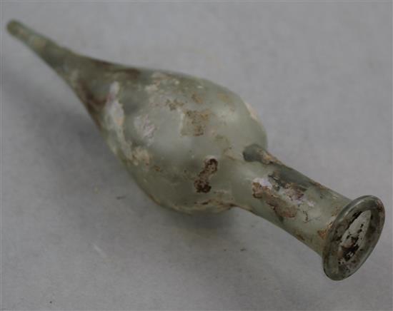 A Roman clear glass spindle flask, c.2nd century AD, 20cm